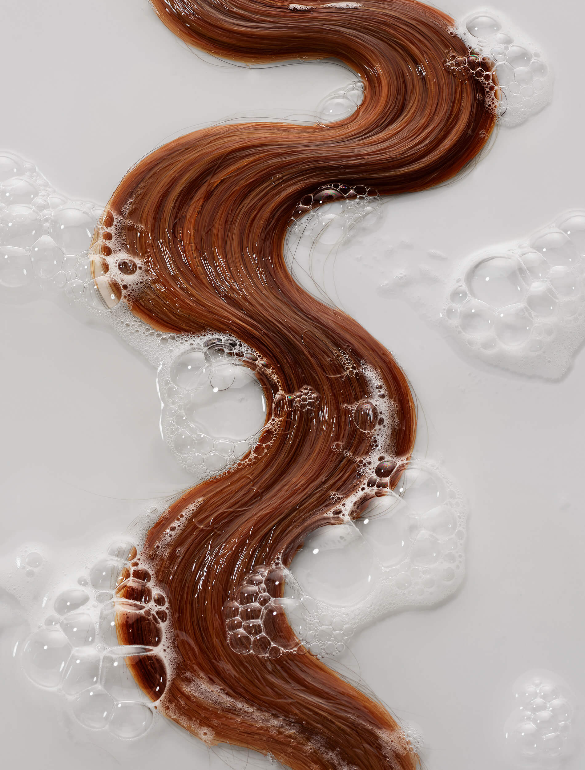 Wet red hair with thickening shampoo suds